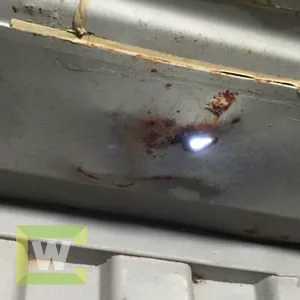 Small daylight hole in a shipping container roof, an easy caulk repair